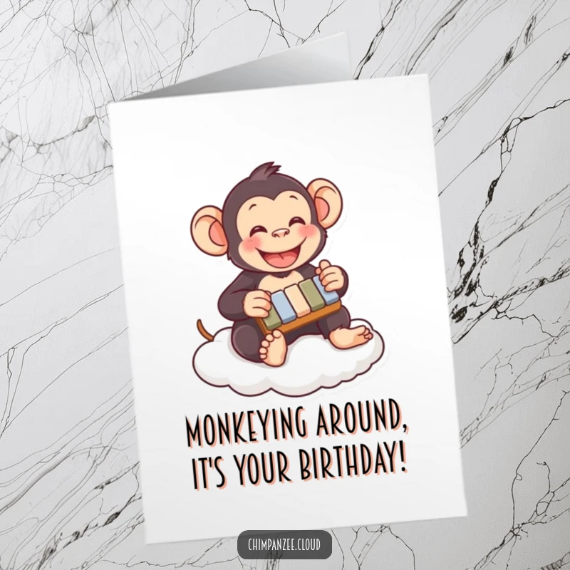 Funny Free Printable Birthday Card: Happy chimpanzee enthusiastically playing a tiny xylophone while sitting on a fluffy cloud.
