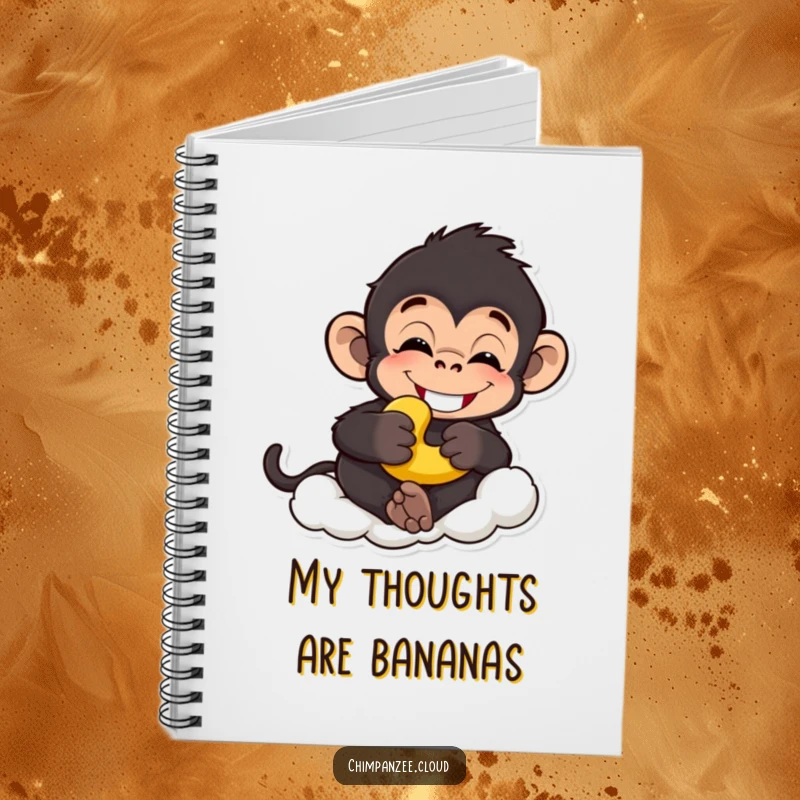 Funny chimp notebook with a grinning chimpanzee holding a banana, relaxed on a cloud, ideal funny gift.